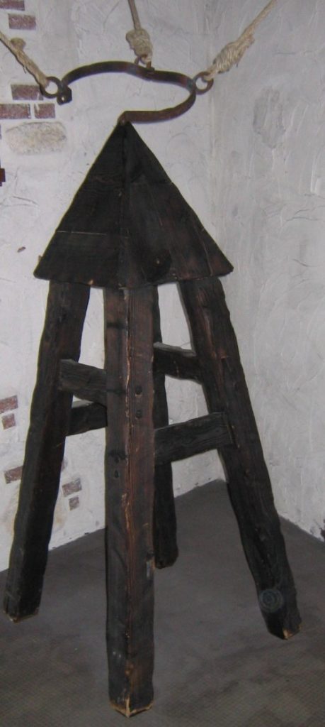 Dispositivo de tortura muy similar a un taburete, de manera, en lugar de asiento tiene una pirámide y sobre este hay unas cadenas de soporte para la víctima.