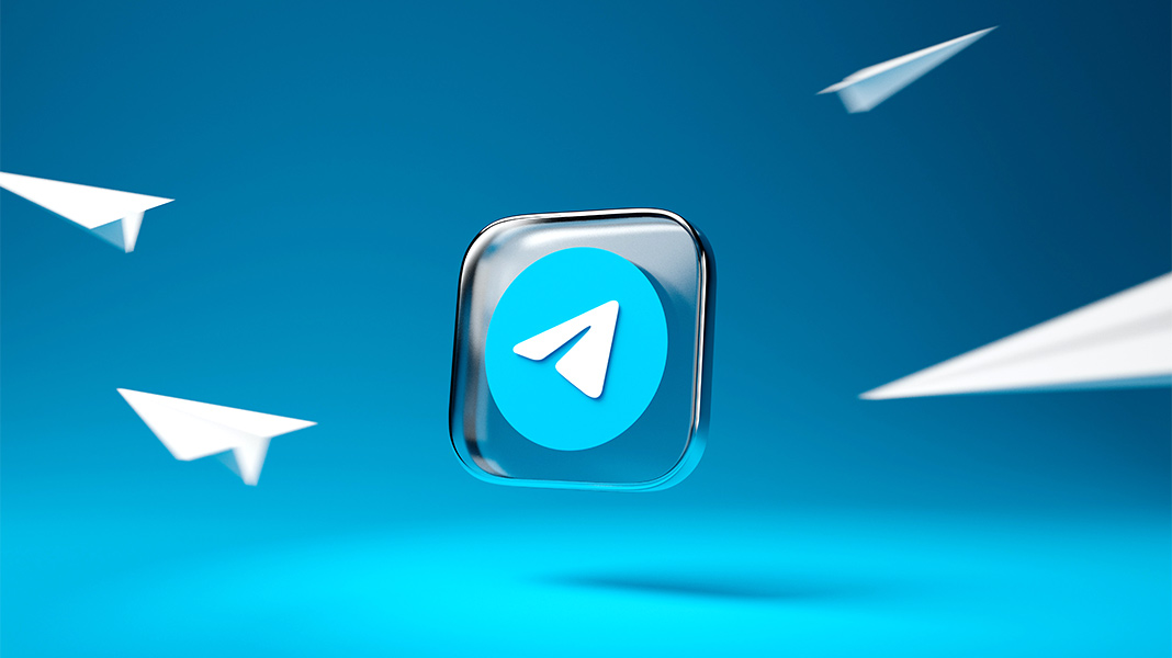 Icono de Telegram rodeado de aviones de papel